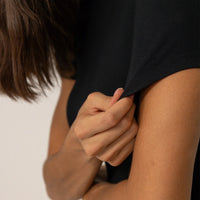 Woman wearing a Fitted T-Shirt in Black, closeup.