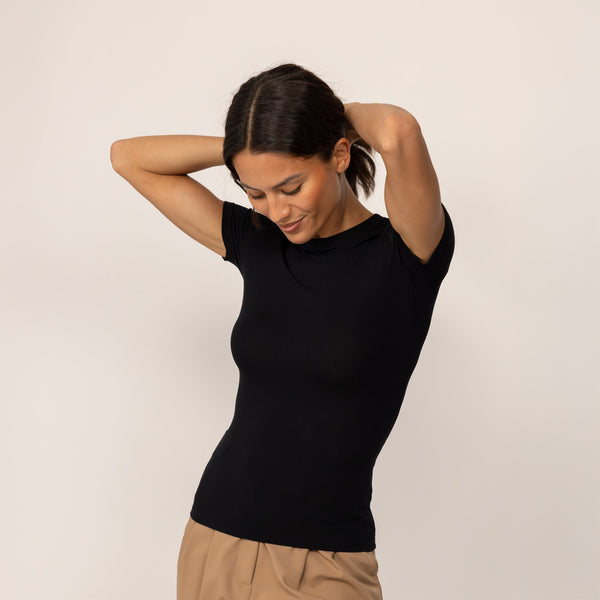 Woman wearing a Fitted T-Shirt in Black, front view.