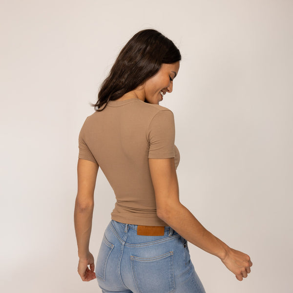 Woman wearing a Fitted T-Shirt in Cinnamon Sugar, rear view.