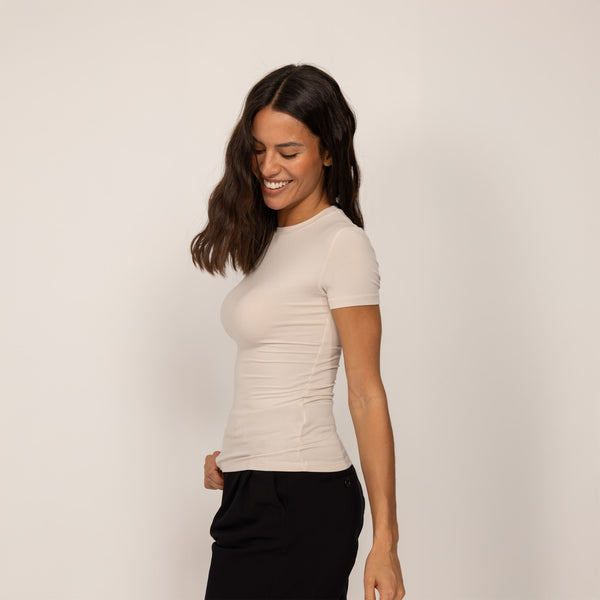 Woman wearing a Marame Fitted T-Shirt in Cosy Cream, front view.