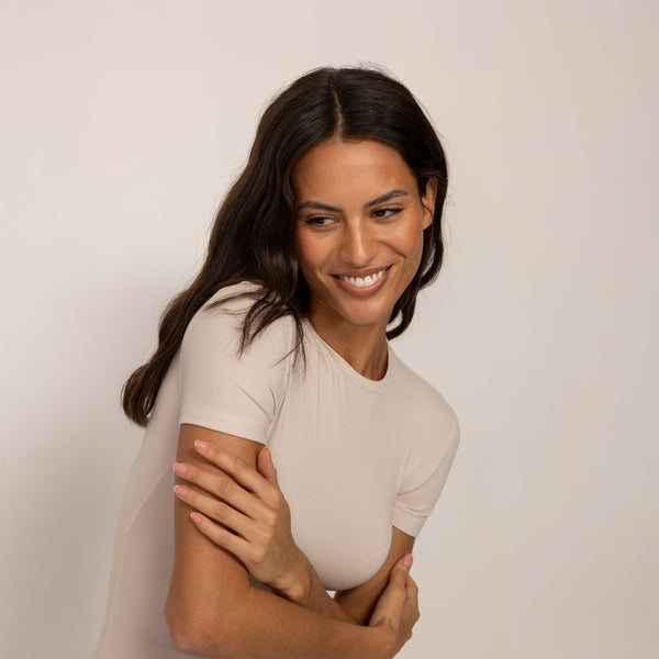 Woman wearing a Marame Fitted T-Shirt in Cosy Cream, front view.