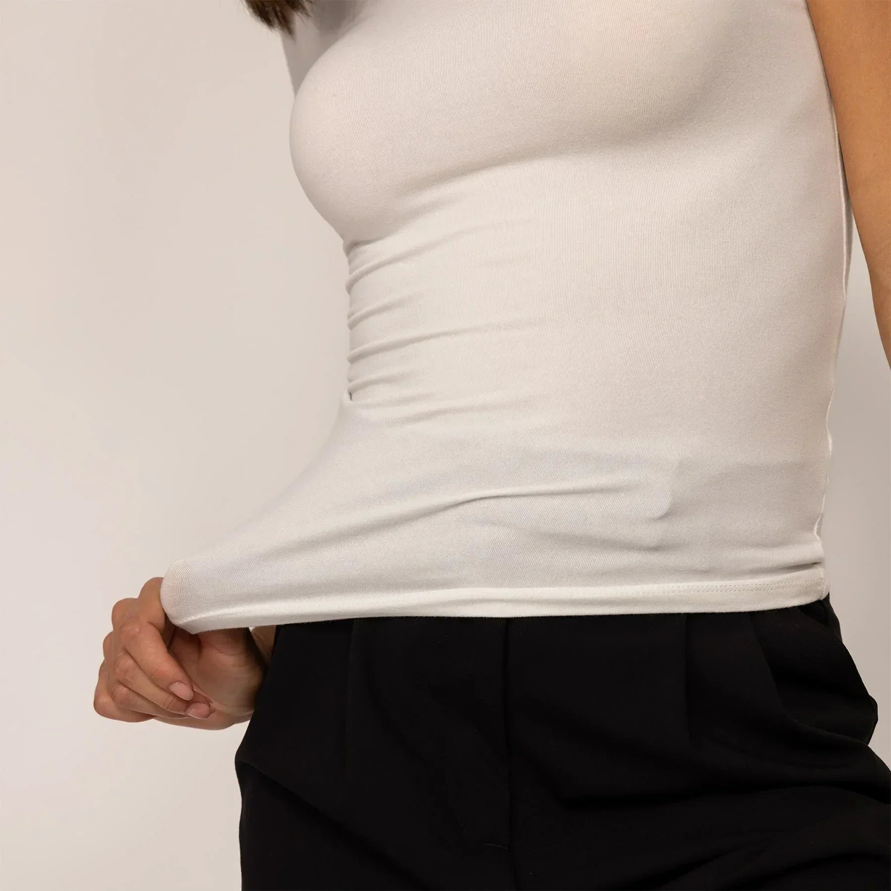 Woman wearing a Marame Fitted T-Shirt in White, closeup.|white