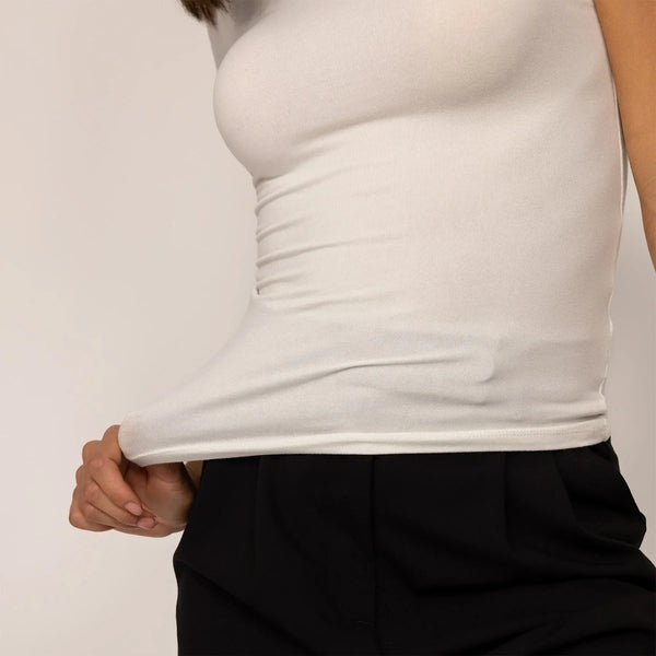 Woman wearing a Marame Fitted T-Shirt in White, closeup.|white