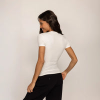 Woman wearing a Fitted T-Shirt in White, rear view.