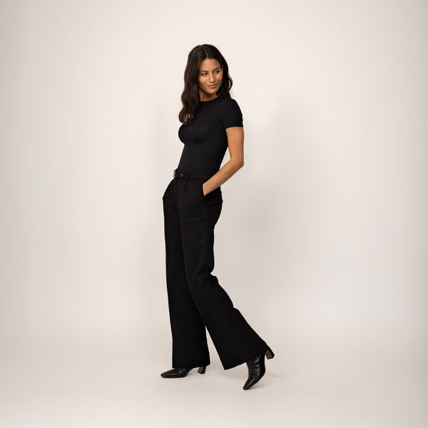 Woman wearing Marame High-Waisted Smart Trousers in Black, full view.