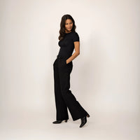 Woman wearing Marame High-Waisted Smart Trousers in Black, full view.