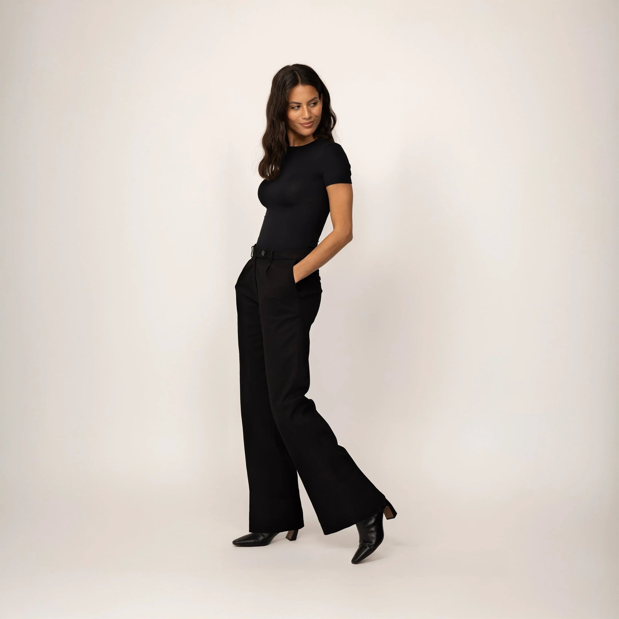 Woman wearing Marame High-Waisted Smart Trousers in Black, full view. |Black