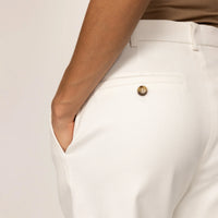 Woman wearing Marame High-Waisted Smart Trousers in White Cream, closeup.