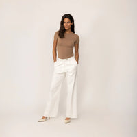 Woman wearing Marame High-Waisted Smart Trousers in White Cream, full view.