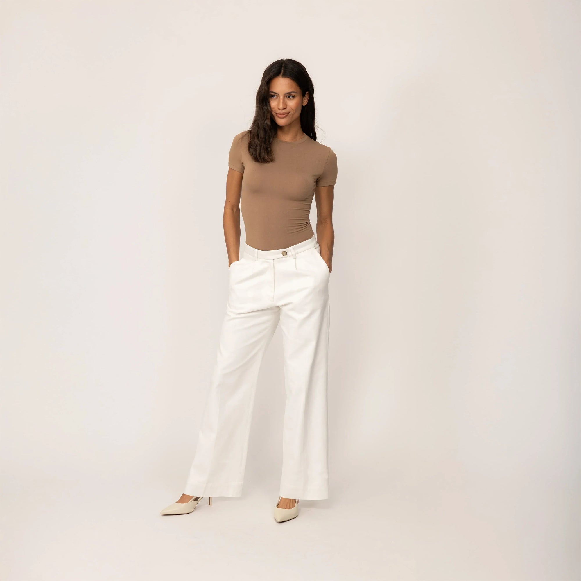 Woman wearing Marame High-Waisted Smart Trousers in White Cream, full view. |white cream