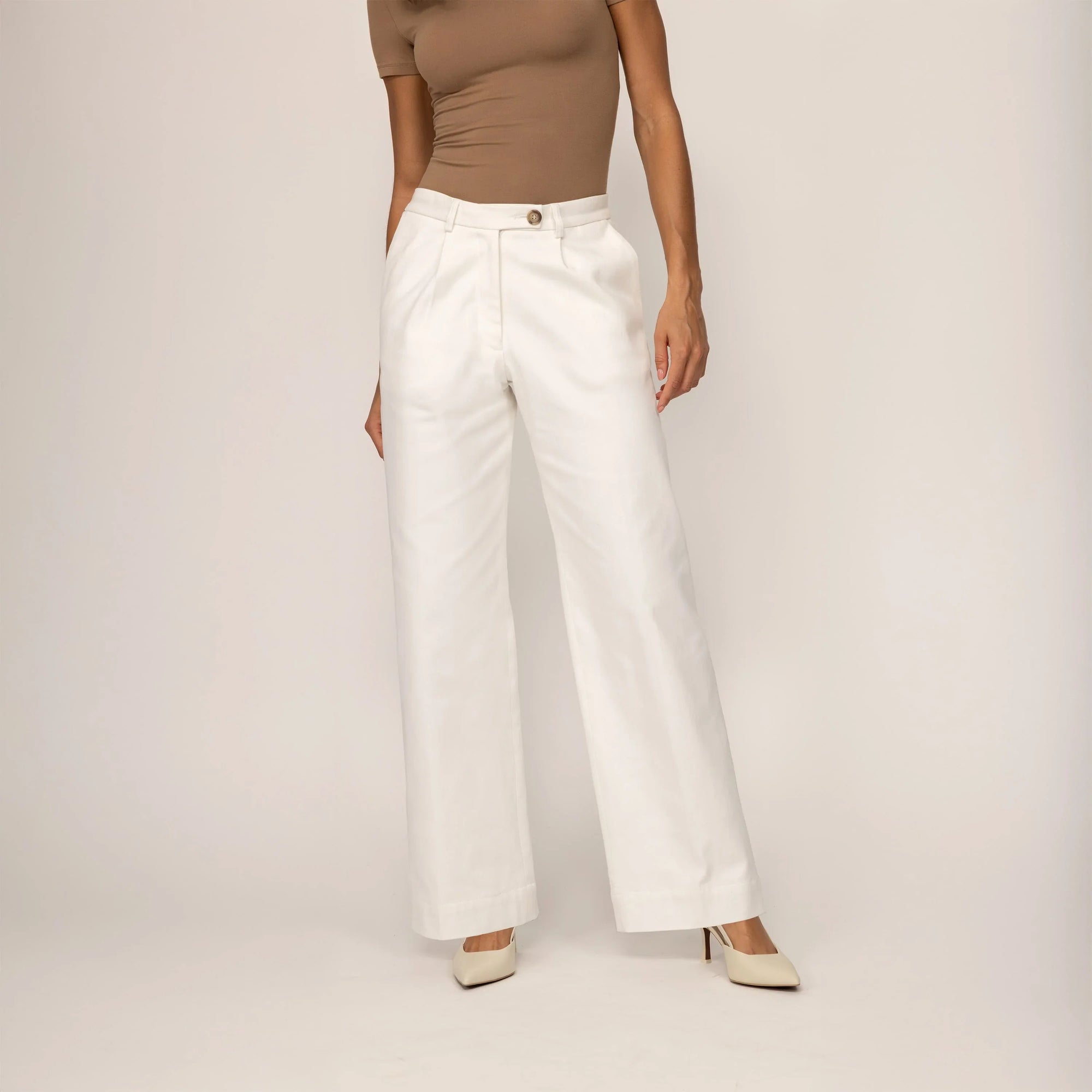 Woman wearing Marame High-Waisted Smart Trousers in White Cream, front view. |white cream