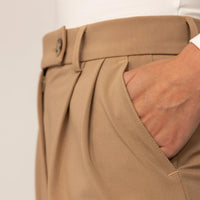 Woman wearing High-Waisted Tapered Trousers in Caramel, detail. |caramel