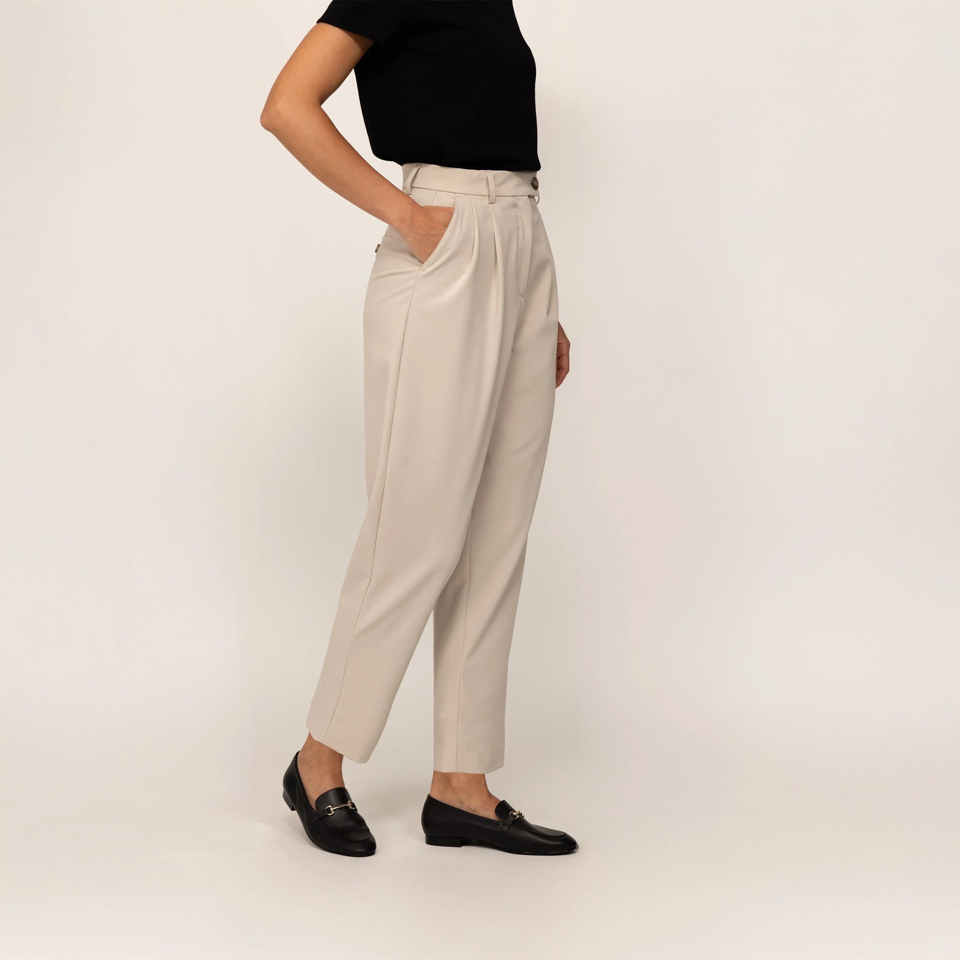 Woman wearing Marame High-Waisted Tapered Trousers in Stone, front view. |stone