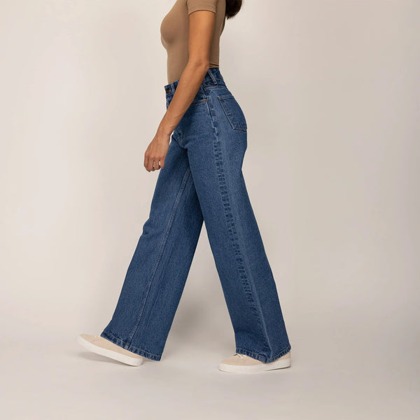 Woman wearing High-Waisted Wide Leg Jeans in Deep Wash Navy Denim, side view. |deep navy wash denim