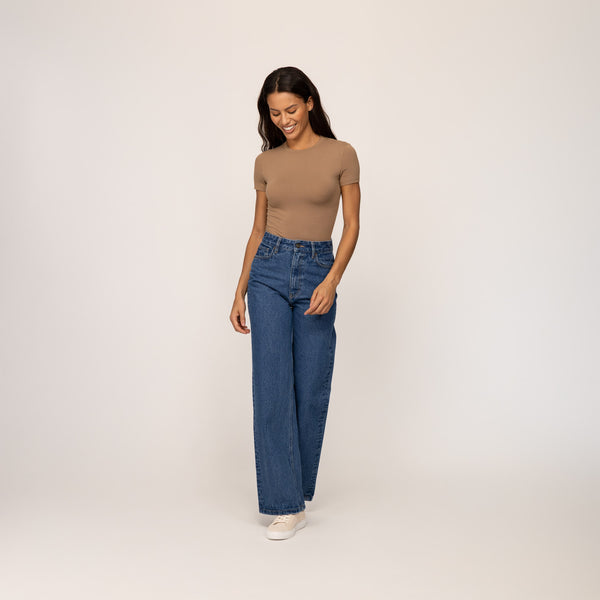 Woman wearing Marame High-Waisted Wide Leg Jeans in Deep Wash Navy Denim, full view.