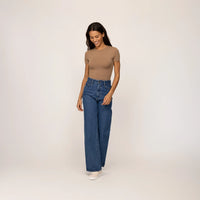 Woman wearing Marame High-Waisted Wide Leg Jeans in Deep Wash Navy Denim, full view.