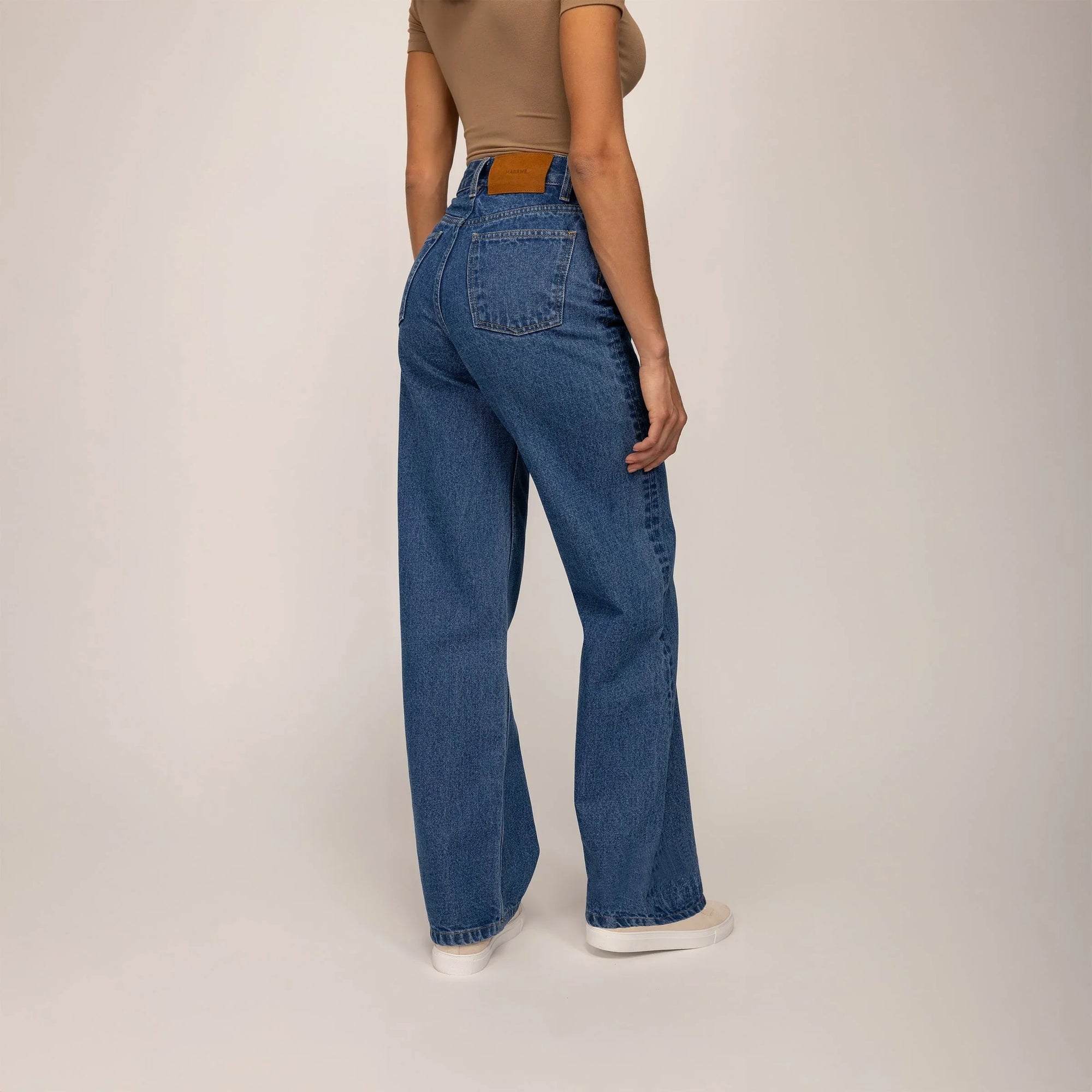 Woman wearing High-Waisted Wide Leg Jeans in Deep Wash Navy Denim, rear view. |deep navy wash denim