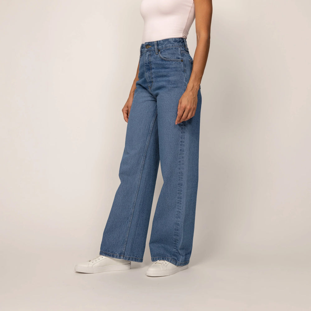 Woman wearing Marame High-Waisted Wide Leg Jeans in Light Wash Denim, front view.