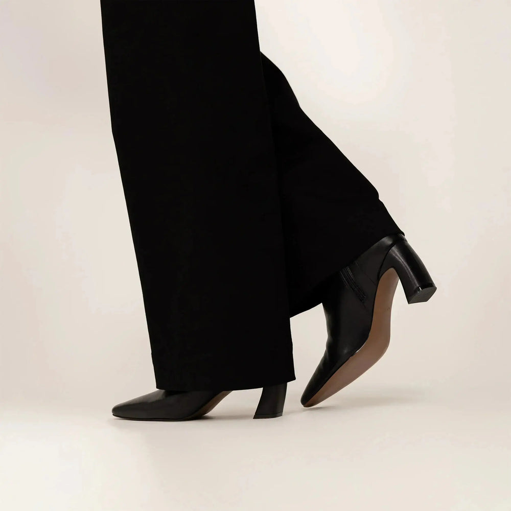 woman wearing Marame Leather Ankle Boots in Black, side view. |black