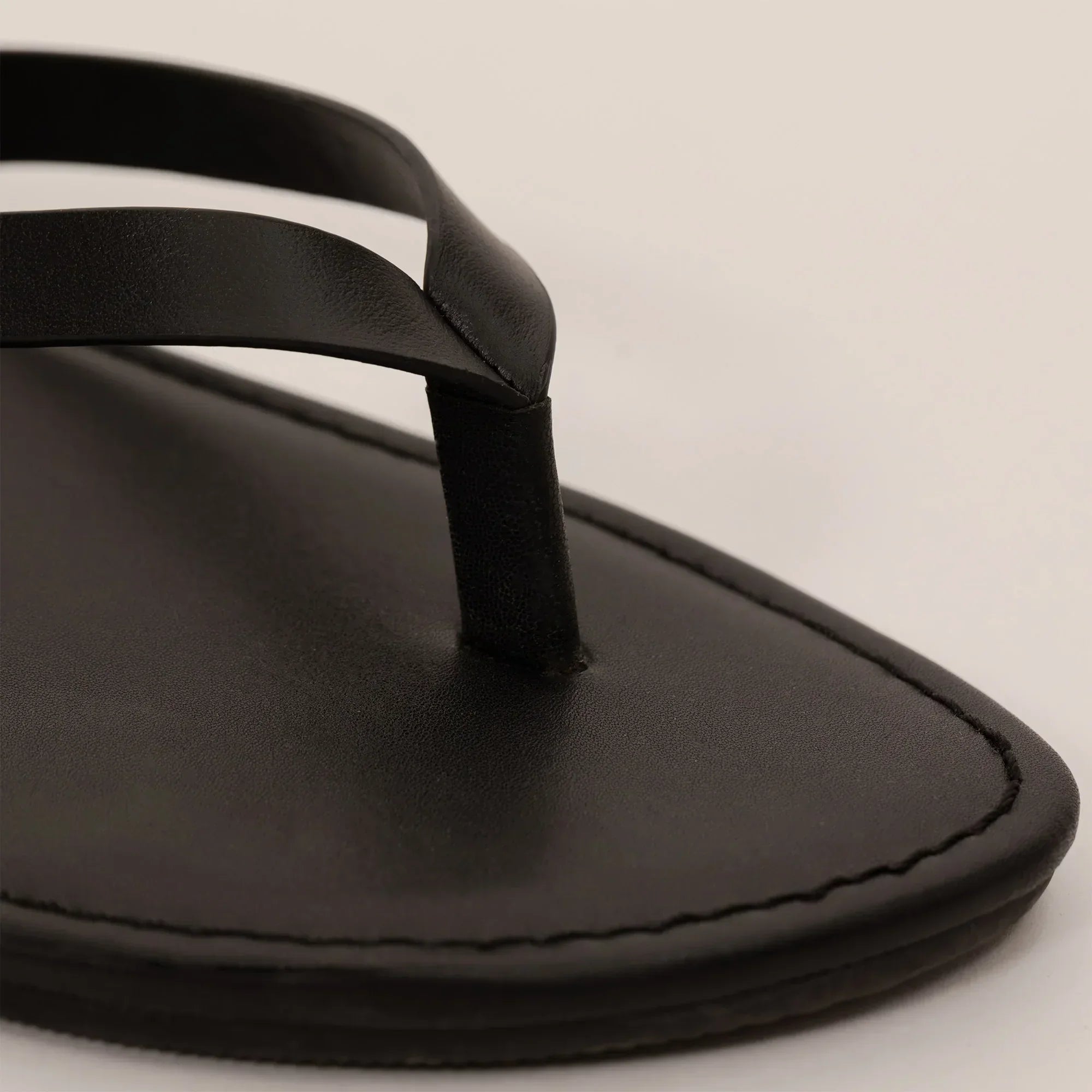 Marame Leather Flip Flops in Black, closeup. |black