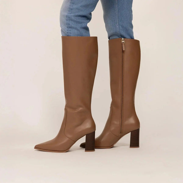 Woman wearing Marame Leather Knee-High Boots in Brown, side view. |brown