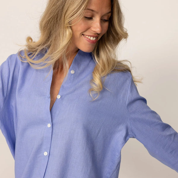Close-up of woman in a blue violet linen shirt, showing relaxed collar and fabric texture