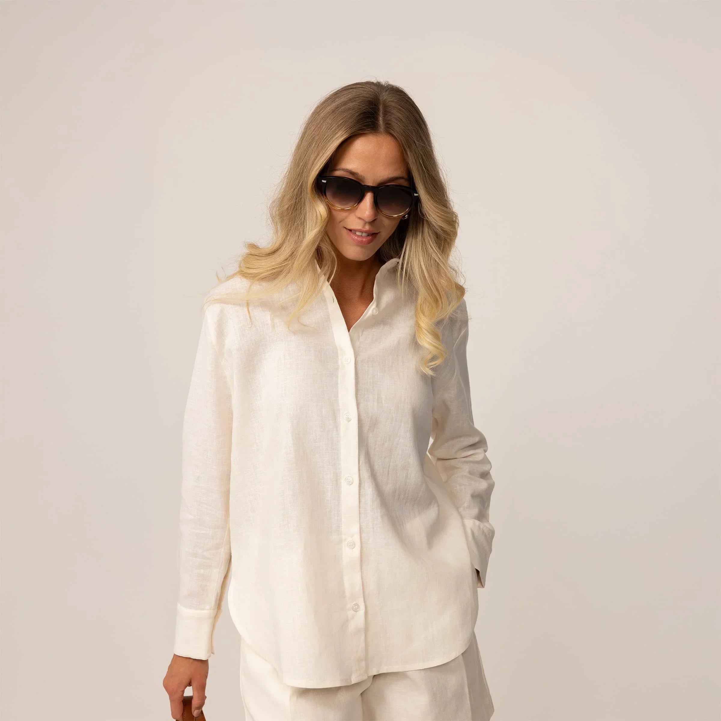Woman posing in off white linen blend shirt and shorts |off white