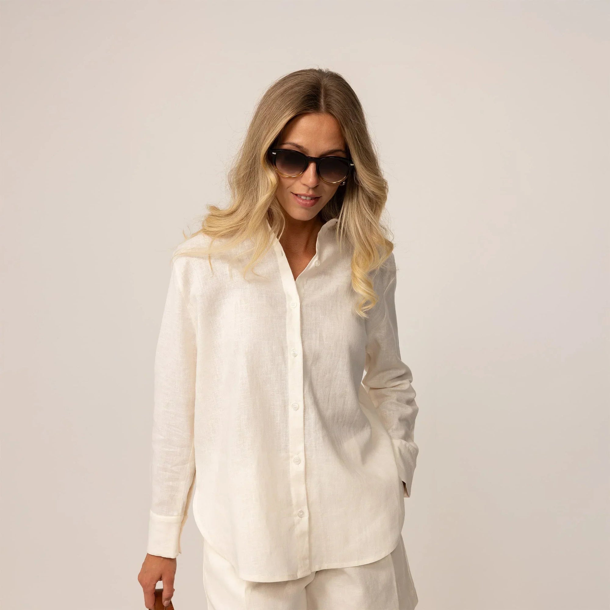 Woman posing in off white linen blend shirt and shorts |off white