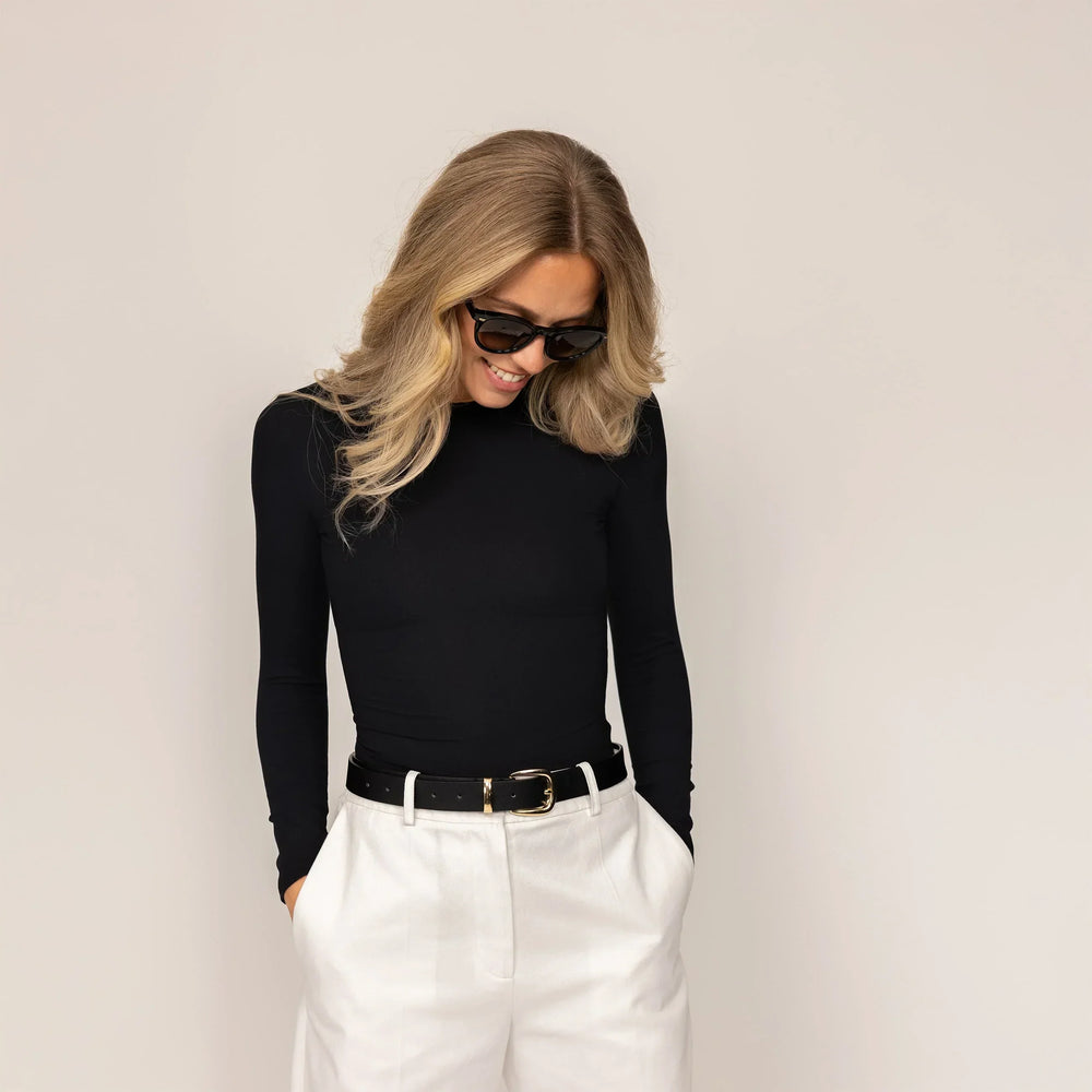 Woman wearing Long Sleeve Fitted T-Shirt in Black, front view.