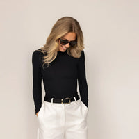 Woman wearing Long Sleeve Fitted T-Shirt in Black, front view.