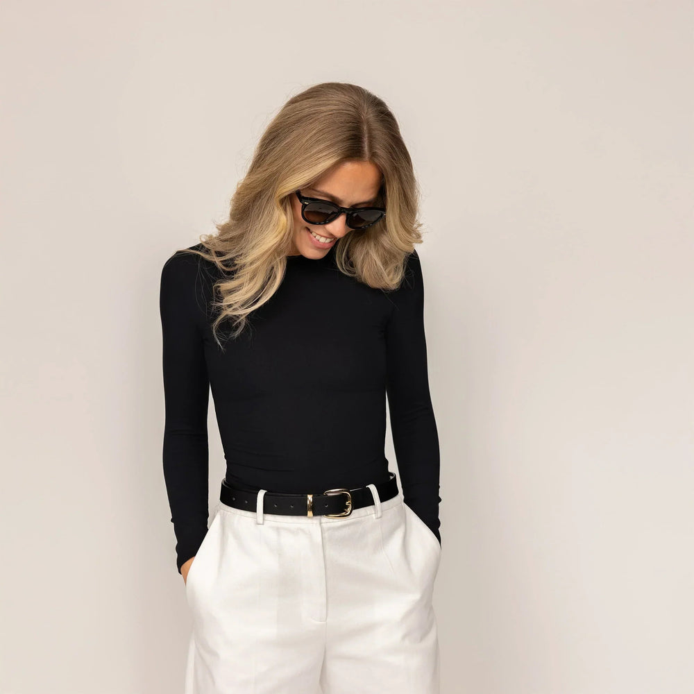 Woman wearing Long Sleeve Fitted T-Shirt in Black, front view.|black