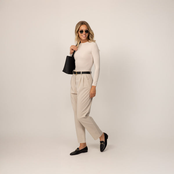 Woman wearing Marame Long Sleeve Fitted T-Shirt in Cosy Cream, front view.