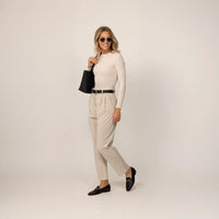 Woman wearing Marame Long Sleeve Fitted T-Shirt in Cosy Cream, front view.