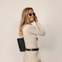 Woman wearing Marame Long Sleeve Fitted T-Shirt in Cosy Cream, side view.