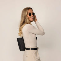 Woman wearing Marame Long Sleeve Fitted T-Shirt in Cosy Cream, side view.|cosy cream