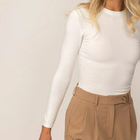 Woman wearing Long Sleeve Fitted T-Shirt in White, closeup.|white