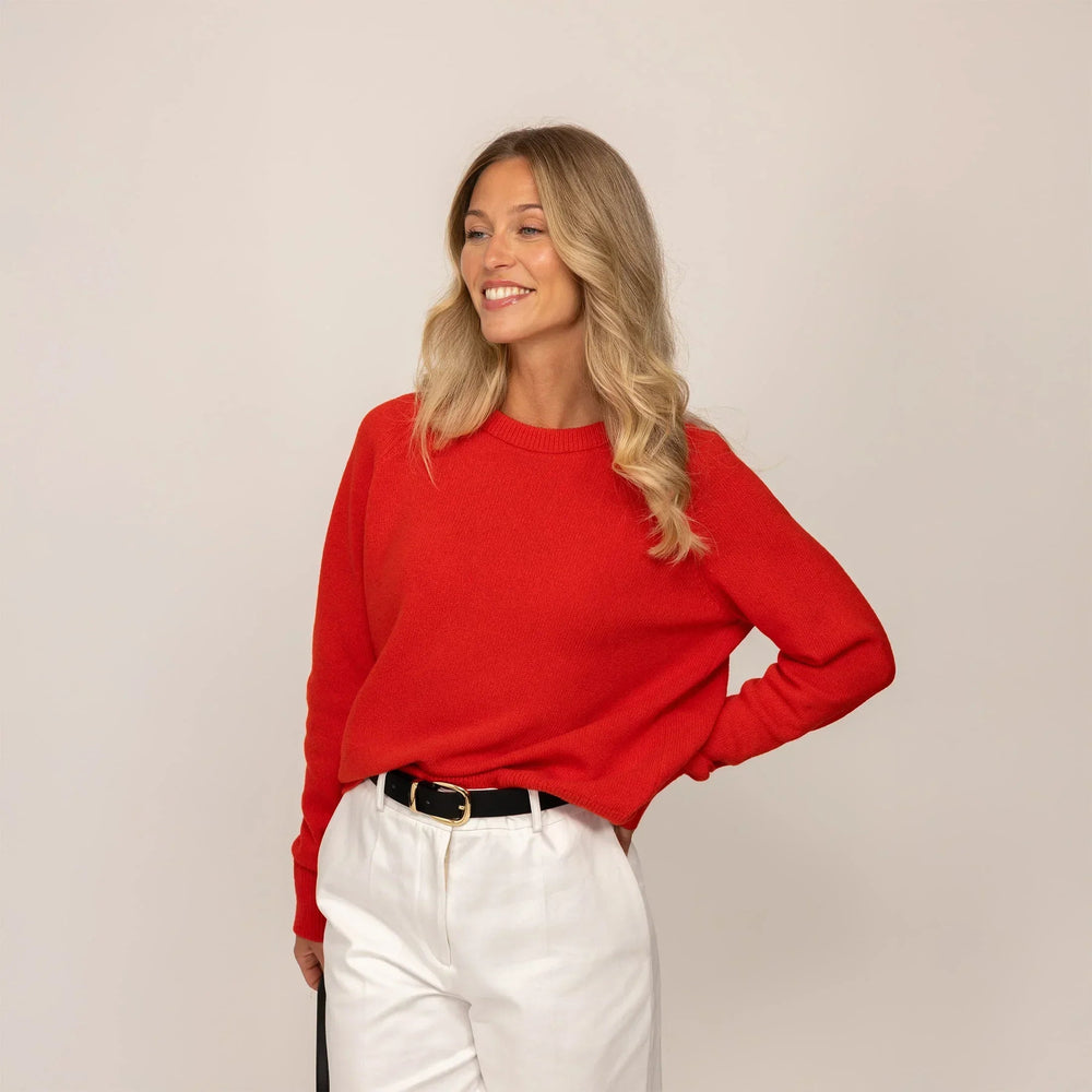 Woman wearing a Marame Merino Wool Crew Neck Jumper in Fiery Rose, front view.|fiery rose