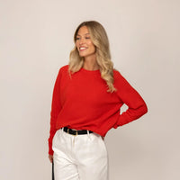 Woman wearing a Marame Merino Wool Crew Neck Jumper in Fiery Rose, front view.|fiery rose