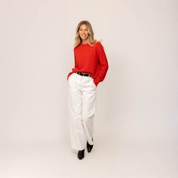 Woman wearing a Marame Merino Wool Crew Neck Jumper in Fiery Rose, full view.