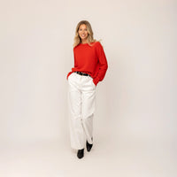 Woman wearing a Marame Merino Wool Crew Neck Jumper in Fiery Rose, full view.