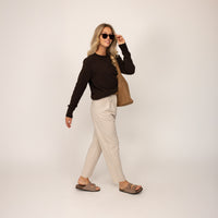 Woman wearing a Marame Merino Wool Crew Neck Jumper in Rich Chocolate, full view.