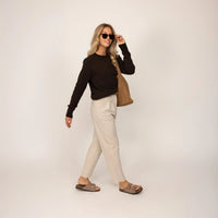 Woman wearing a Marame Merino Wool Crew Neck Jumper in Rich Chocolate, full view.|rich chocolate