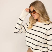 Woman wearing a Marame Merino Wool Crew Neck Jumper in Vanilla Cream/Black, closeup.|Vanilla Cream/Black