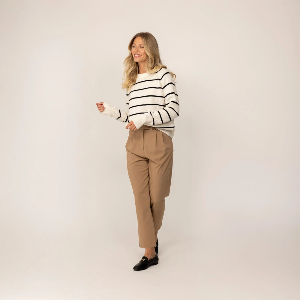 Woman wearing a Marame Merino Wool Crew Neck Jumper in Vanilla Cream/Black, full view.