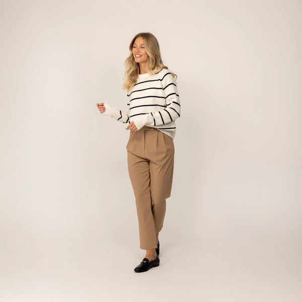 Woman wearing a Marame Merino Wool Crew Neck Jumper in Vanilla Cream/Black, full view.|Vanilla Cream/Black