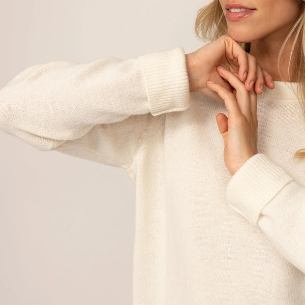 Woman wearing a Merino Wool Crew Neck Jumper in Vanilla Cream, closeup.