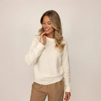 Woman wearing a Marame Merino Wool Crew Neck Jumper in Vanilla Cream, front view.|vanilla cream