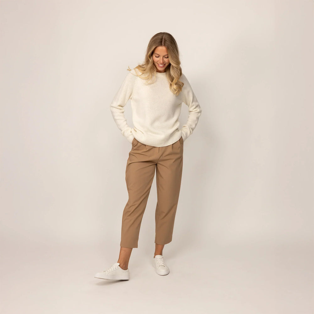 Woman wearing a Marame Merino Wool Crew Neck Jumper in Vanilla Cream, front view.