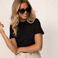 Woman wearing a Regular Fit T-Shirt in Black, front view.