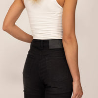 Woman wearing Slim Leg Jeans in Black Wash Denim, closeup. |black wash denim